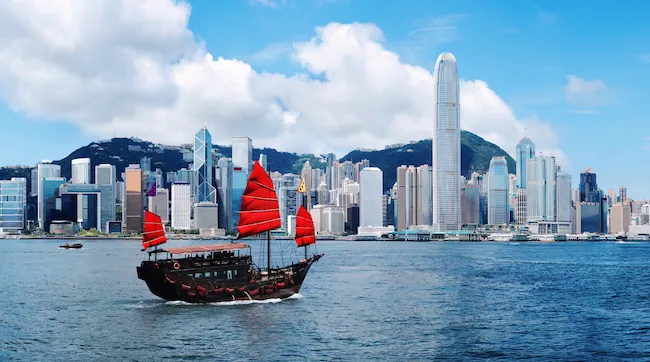 Traditional junk boat with red sails in Victoria Harbour, Hong Kong